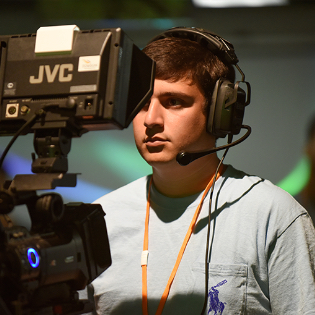 Towson University student operating media equipment